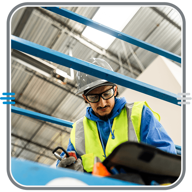Magic Valley Electric electrician working on electrical equipment from a warehouse lift